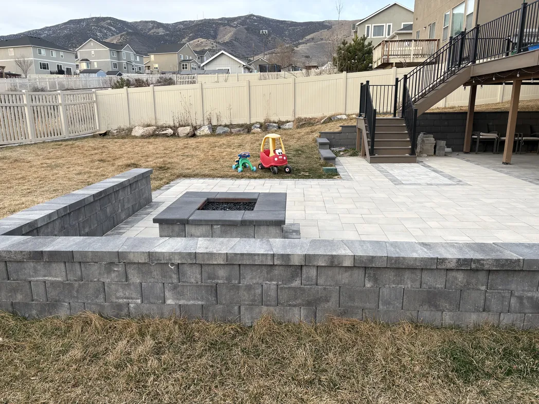 Backyard paver patio with fire pit and open seating area