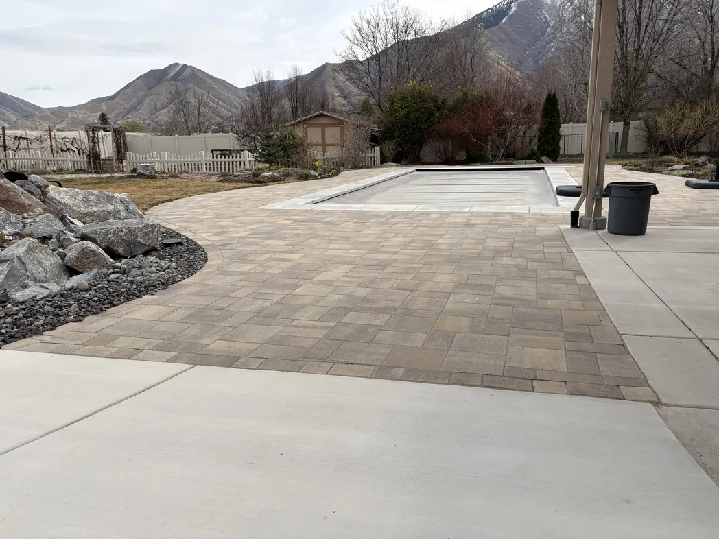 Poolside paver patio with mixed hardscape surfaces