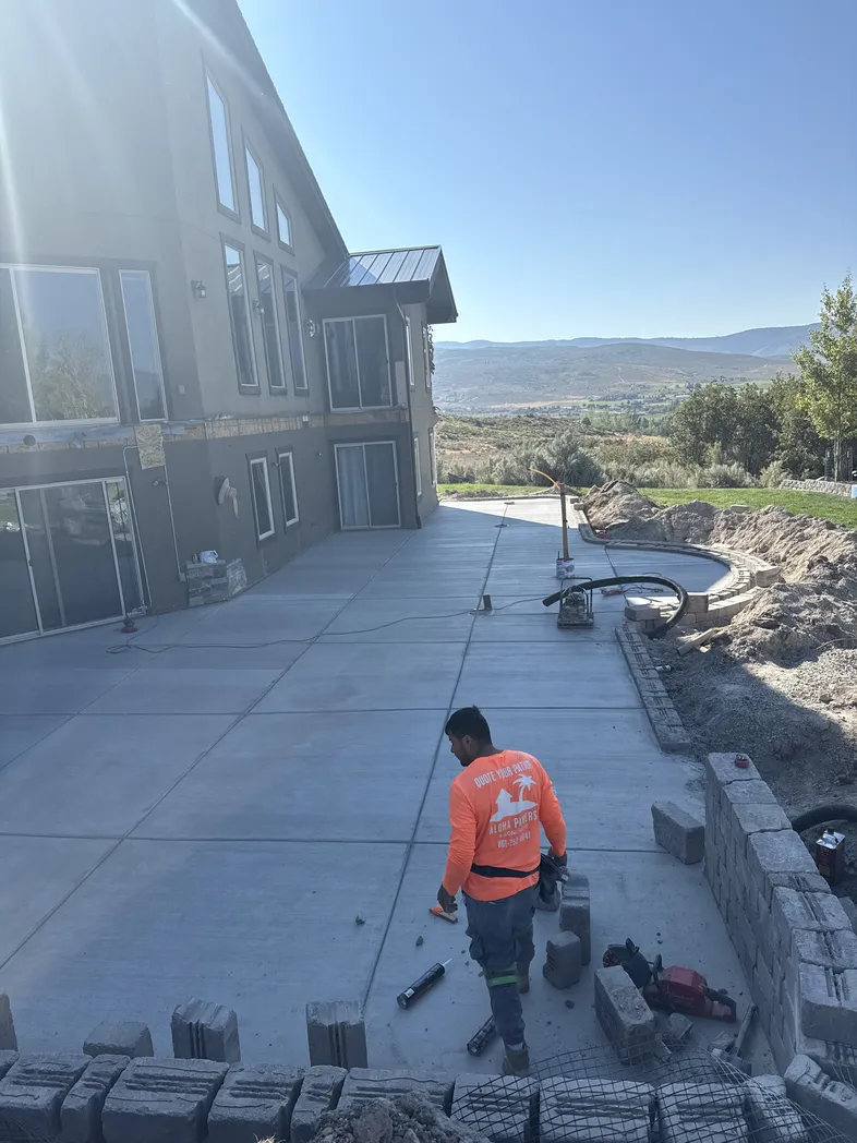 Retaining wall installation in progress with block placement on a residential property